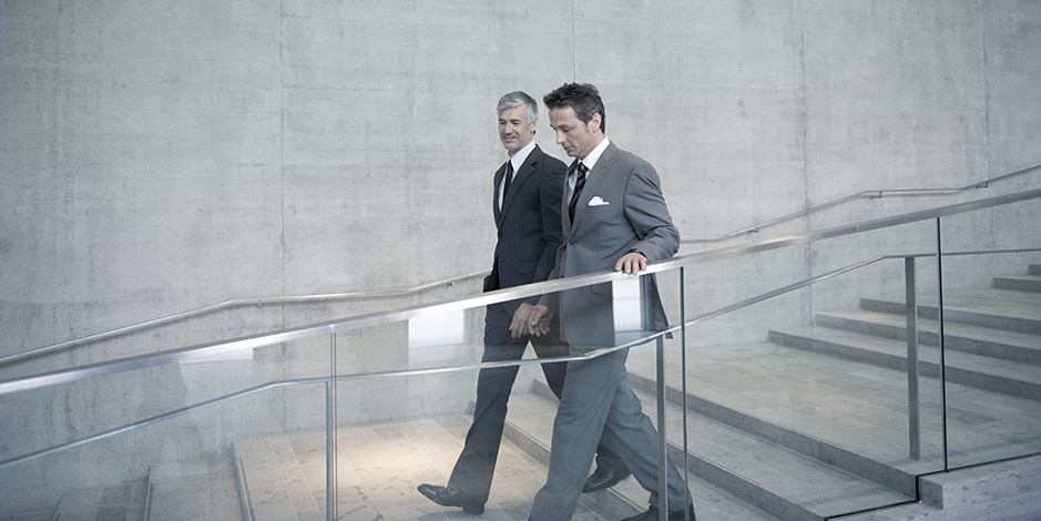 Businessmen walking down stairs
